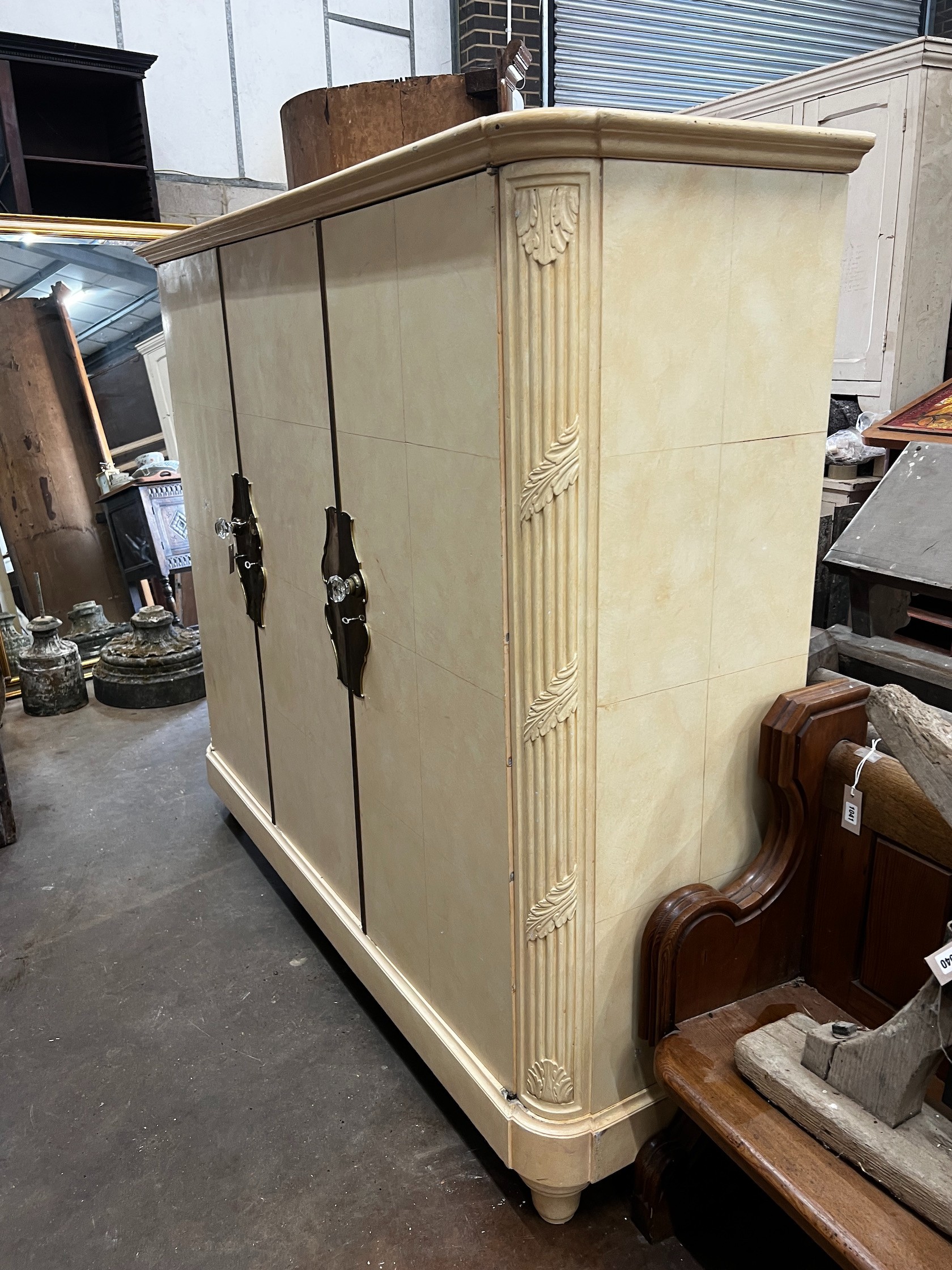 An early 20th century French brass mounted oak compactum wardrobe, width 196cm depth 56cm height 170cm